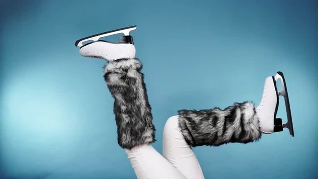 Woman legs wearing ice skates fur socks, skating 4K