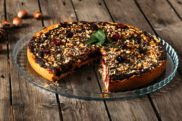 Cherry pie on dark wooden table