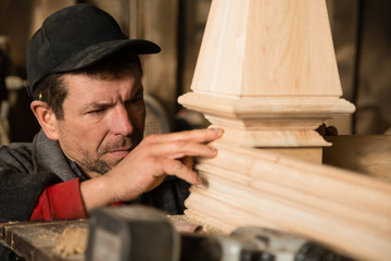 Carpenter inspects to make furniture