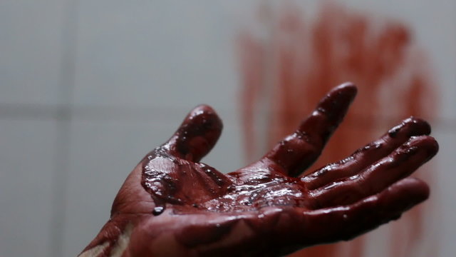 Closeup shot of Murderer's shows bloody hands 
