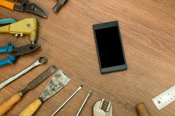 different old tools with smart phone on wood ,technology tools concept