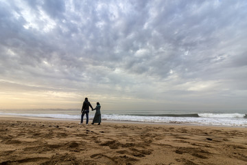 Couple walking at Sunset in Dar Bouazza beach, in Tamarist © Carlos Neto