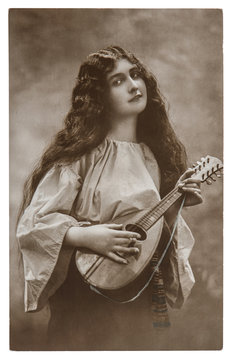 Beautiful young girl with mandolin. Vintage picture