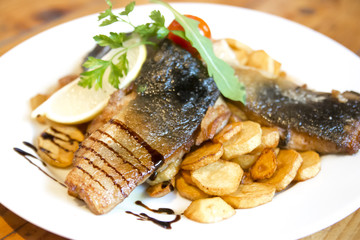 Fried carp fillet with fried potatoes