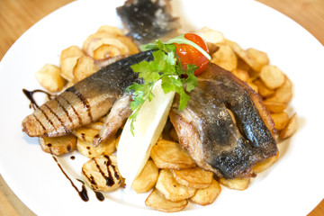 Fried carp fillet with fried potatoes