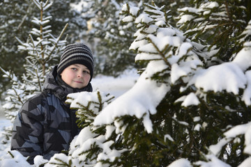 teenage boy at a pine forest in winter