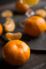 Oranges and juice on the dark background. Shallow depth of field. 