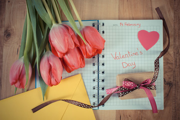 Valentines Day written in notebook, fresh tulips, love letter, gift and heart, decoration for Valentines