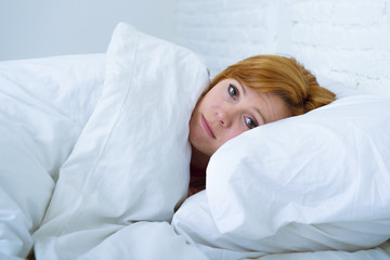young woman  lying in bed sick unable to sleep suffering depress