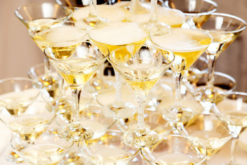 Pyramid of glasses with champagne close up