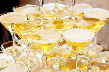 Pyramid of glasses with champagne close up