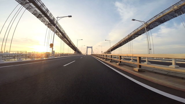 Sunrise drive over the Rainbow Bridge in Tokyo.