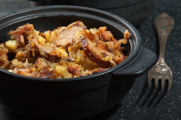 Potatoes baked with sausage and bacon
