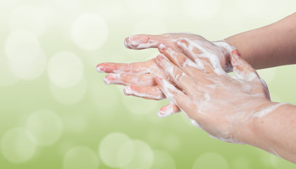Naklejka premium Washing hands. Hygiene concept. Green bokeh background.