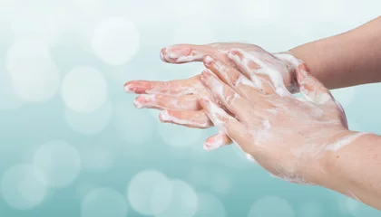 Fotobehang Washing hands. Hygiene concept. Blue bokeh background. © vchalup