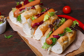 home made Hot dog - sandwich with lettuce on wooden background