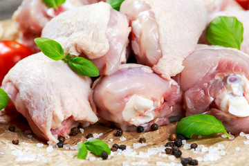 Raw Chicken Drumsticks with basil and pepper, salt