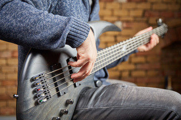 Bass guitar being played in a sound studio