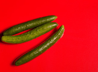 Japanese cucumbers on a bright red cutting board