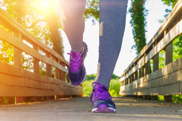Woman running at sunset in a field