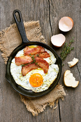 Fried eggs with bacon, top view