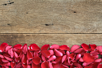 Beautiful red roses petals  on wooden.Valentine's Day, anniversary etc background.