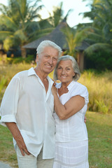 elderly couple rest at tropical resort