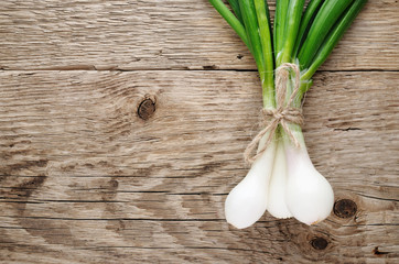 Green onion on wooden table top view
