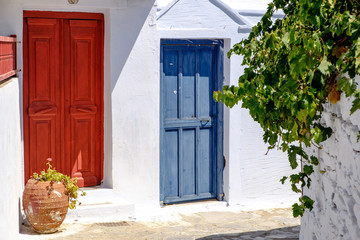 Fototapeta na wymiar Colorful doors in white mediterranean street, Amorgos, Greece