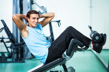 Man exercising in gym doing sit ups