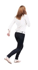 back view of running  woman in jeans