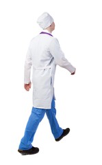 Back view of walking doctor in a robe hurrying to help the patie