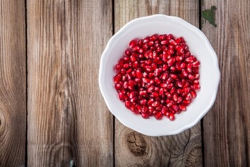 Fresh juicy pomegranate seeds on a plate