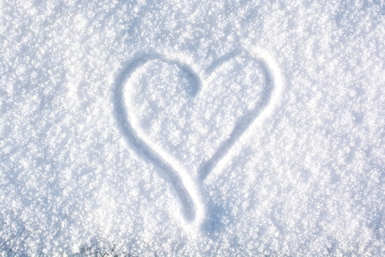 A drawing of a heart in the snow
