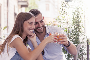 young couple takes a drink in a downtown bar