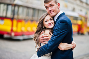 Wedding couple walking on tram ways