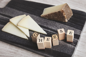 Close up side letters cheese ahead unfocused goat cheese