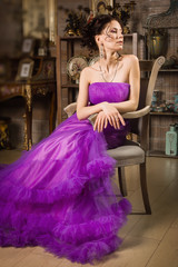 Fototapeta premium Beautiful woman dressed in long lace dress in a vintage interio