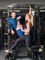 Gym woman exercising with her personal trainer