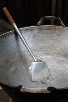 Empty big pan and scoop or flipper used in frying.