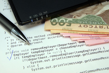 Ukrainian money gryvna, calculator, bancnote and pen on document