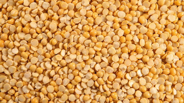 Rotation of a dried yellow peas (background)
