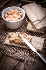 Homemade sandwiches with crisp bread, tuna and egg on a wooden t