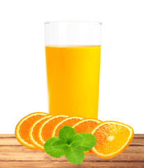 orange juice in the glass and slices on table isolated on white