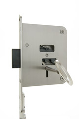 View of a basic door lock in the locked position. The inside mechanism is visible through openings. Sample with inserted key.