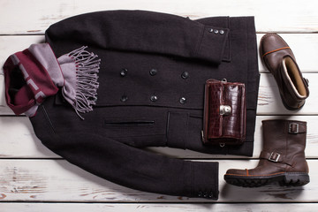 Stylish men's clothing in wooden background.