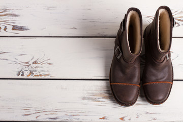 Winter boots on a wooden boards.