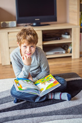 Fototapeta na wymiar Schoolboy having fun while reading