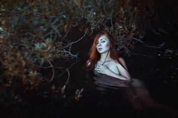 mermaid redhead woman in the water