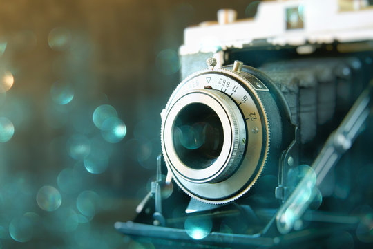 abstract photo of old camera lens with glitter overlay. image is retro filtered. selective focus
